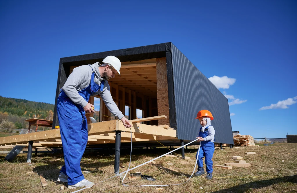 father-with-toddler-son-building-wooden-frame-house