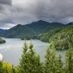 Forested hills around a lake in western Washington under cloudy skies