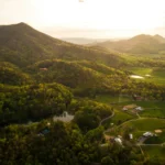 Aerial view of farmland in a green Tennessee mountain valley at sunset