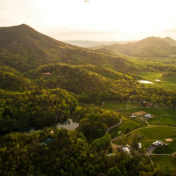 Aerial view of farmland in a green Tennessee mountain valley at sunset