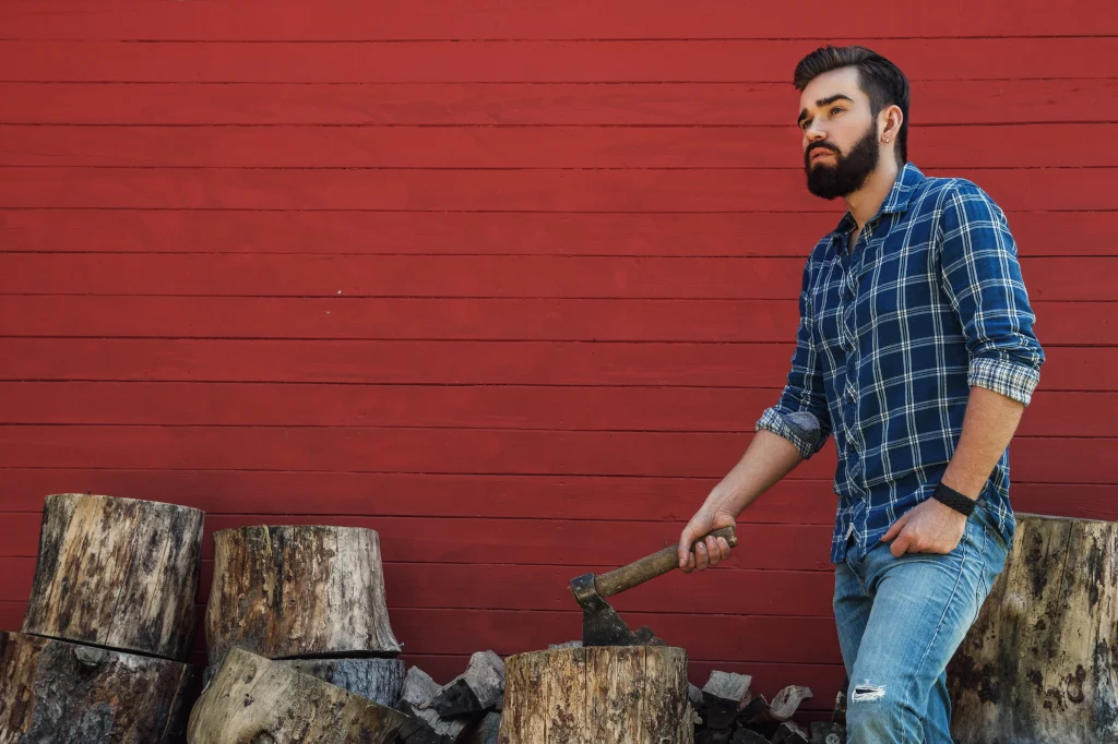 handsome-bearded-man-in-checkered-shirt-with-axe