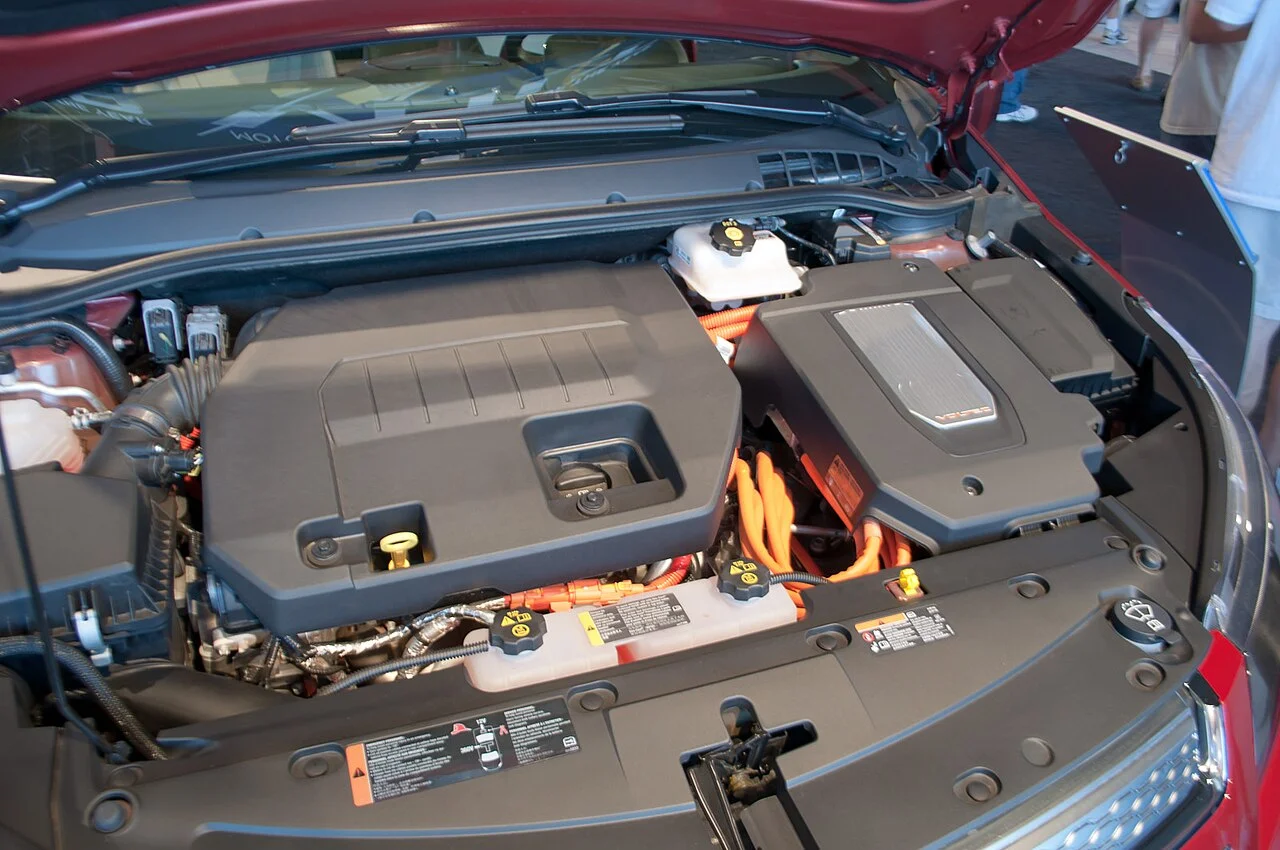 Power inverter backup: the engine bay of a hybrid car with the 12 V battery and alternator